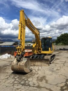 A yellow crane vehicle parked on an open space