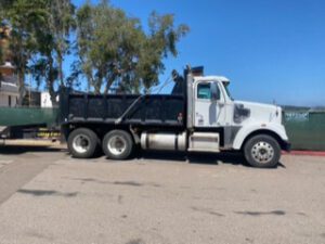 A white truck with a black trailer